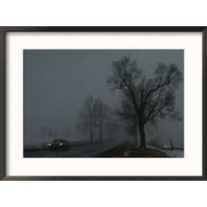 foggy winter view of a car driving down Highway 11 Scenic Framed Art 