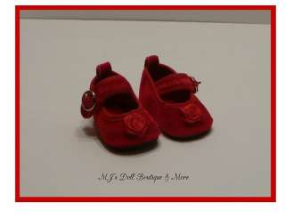 These shoes are red velvet mary janes that have a rose on the toes 