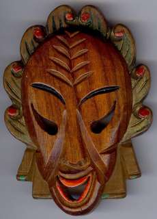 This large vintage painted carved wood mask face pin from the 1930s 